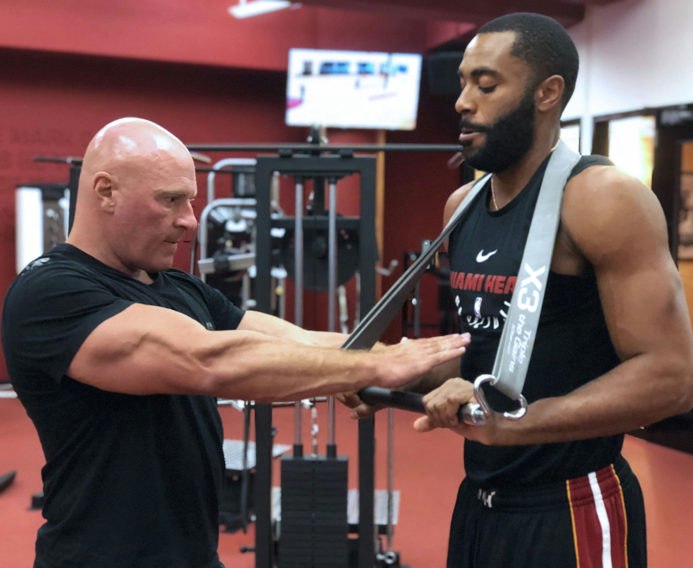 John Jaquish showing how to perform an X3 exercise with the Miami Heat